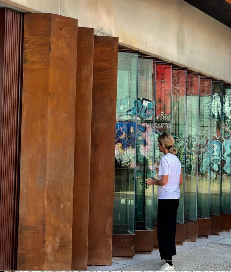 Hackney Wick Station - View of the Corten and Molecular Glass Wall reflecting the red H W building opposite, Landolt + Brown Architects in collaboration with Artist Wendy Hardie. Photo by Wendy Hardie, 2018