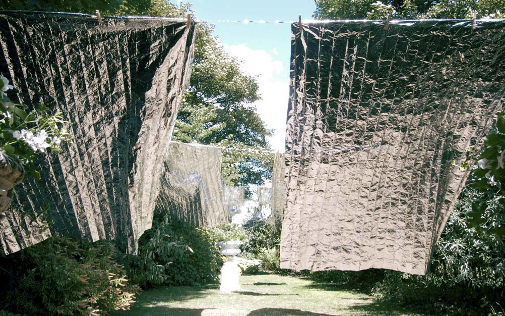 'Laundry Day' by artist Wendy Hardie. A site specific environmental art installation of rows of emergency blankets on silver washing lines, Durham 2006.